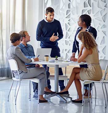 a group of employees having a discussion on a circular table