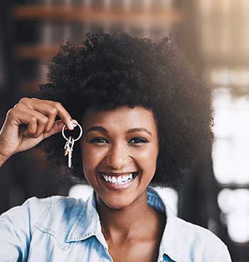 cropped shot of an attractive young woman holding a key