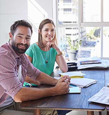 Well achieve success together. Cropped portrait of two young designers sitting in the boardroom.